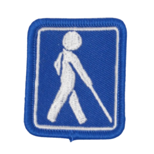 Emblem med blindesymbol. Maskinbroderet  til at sy på tøj.